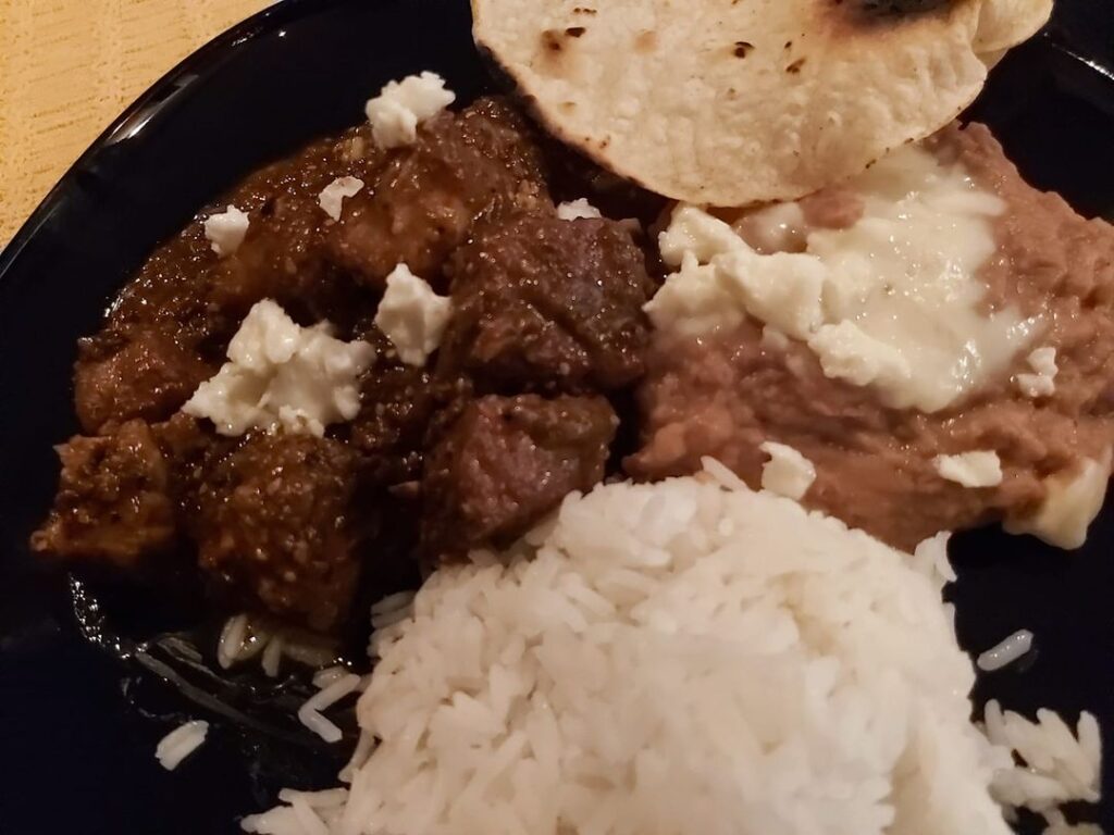 pork in tomatillo with beans, rice, and corn tortillas